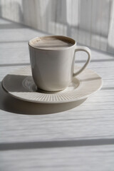 photo white cup with coffee on a saucer