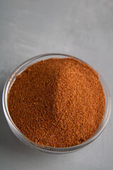 photo paprika poured in a glass deep dish