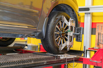 CLose-up car wheel indoors service maintenance repair center.