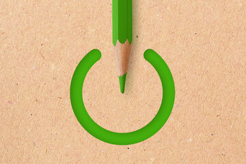 Green power symbol with green pencil on recycled paper background -  Concept of ecology and creative thinking