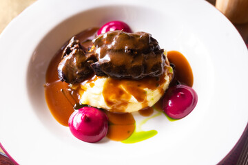 beef cheek with mashed potatoes and currant oil