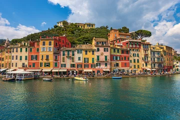 Peel and stick wall murals Liguria Multi coloured houses and port of Portofino, luxury tourist resort in Genoa Province, Liguria, Italy, Europe. Waterfront and promenade with many tourists on a sunny spring day. Mediterranean sea.