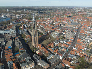 Obraz premium The towering church spire of Onze Lieve Vrouwetoren rises above the charming medieval city of Amersfoort.