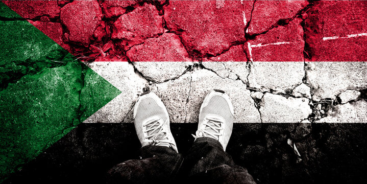 Double exposure of Sudan flag on cracked stone background. Symbols depicting the Civil War. Civil war between Sudanese government forces and paramilitary Rapid Support Forces.