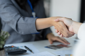Young businesswoman, company worker shaking hands congratulating customer approved credit card and credit limit, benefit, insurance concept, loan, payment.