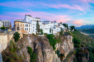 Fototapeta na wymiar Puente Nuevo in Ronda, in the province of Malaga, overlooking the gorge and hanging houses during a sunny summer day