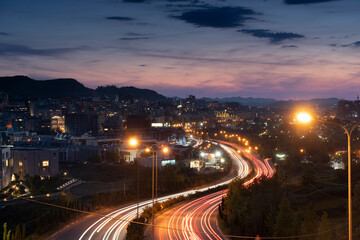 Albania, Tirana street view main road to city entrance, night car light strip