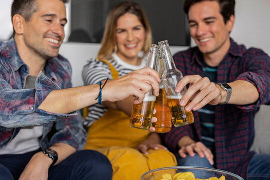 home party friends toasting with beer bottles