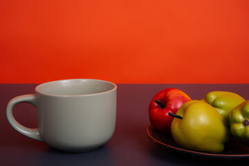 Mug of fragrant drink on an orange background.