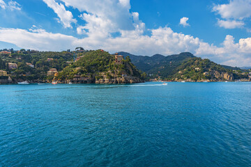 Fototapeta na wymiar Coast of the famous village of Portofino, with the bay of Paraggi and Santa Margherita Ligure town.Luxury tourist resorts in Genoa Province, Liguria, Italy, Europe.