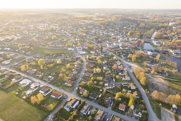 Aerial view of European village with many private houses. Sunset in residential area, urbanism. 