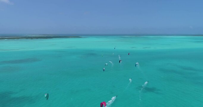 Aerial shot group people kitesurf on caribbean sea sailing kitesafari los Roques