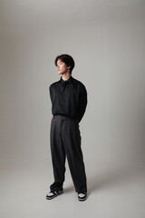 Confident young Asian man posing in the studio. Vertical mock-up. Mind set.
