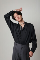 Fototapeta premium Confident young Asian man with calm face expression. Vertical mock-up. Mind set.