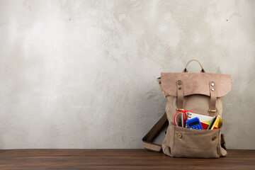Back to school - books and school backpack on the desk in the auditorium, Education concept.