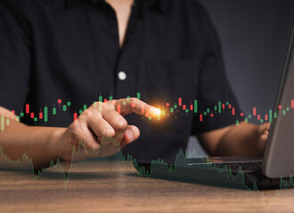 Stock exchange market analysis. A businessman or trader pointing to a graph stock on a virtual screen
