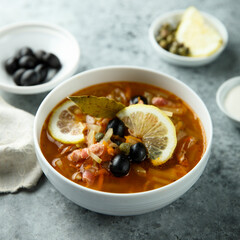 Traditional homemade soup with sausage and capers