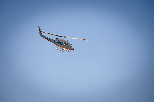 BELGRADE, SERBIA - JULY 20, 2022: Selective blur on a Bell 212 helicopter above Belgrade belonging to Policija srbije, the serbian police forces, in an airborne law enforcement operation.