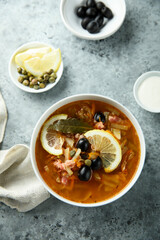 Traditional homemade soup with sausage and capers