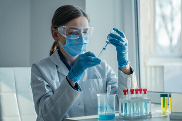 A medical specialist injects patient in chemical laboratory, helping him restore health. Doctor injects patient with vaccine against the virus in a medical laboratory, protecting him from the disease.