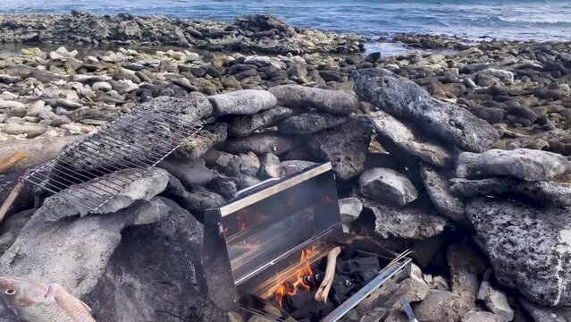 Seafood preparation on BBQ, grouper fishes caught ready to cook  on rustic beach grill