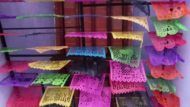 Dolly shot under Mexican Fiesta Papel Picado Garland blowing in the wind