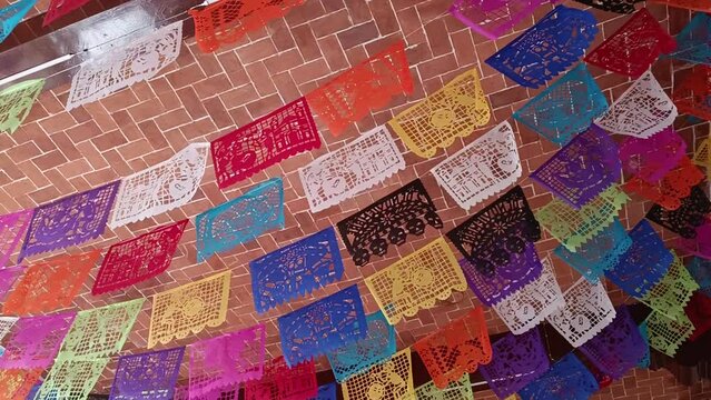 Slow revealing shot of Mexican Fiesta Papel Picado Garland hanging 