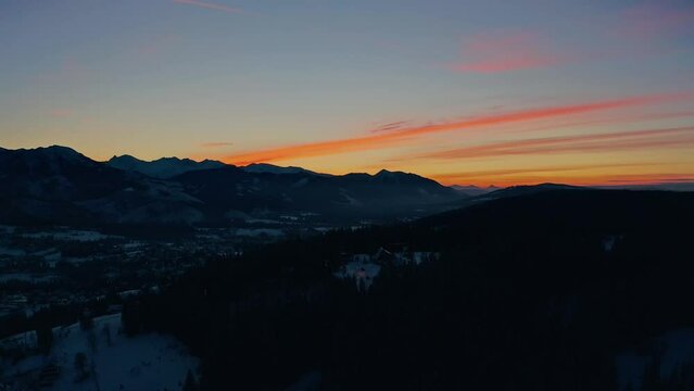 STUNNING Sunset with colourful sky in winter - Drone Aerial Shot of snow landscape
