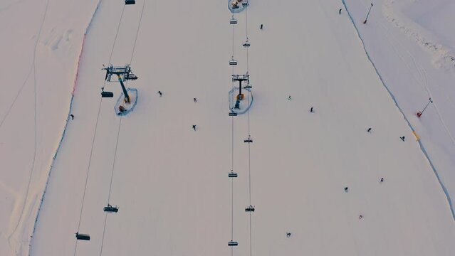 4K Aerial Top Down Reveal of Ski Lift Sunset Winter Snow Landscape Poland