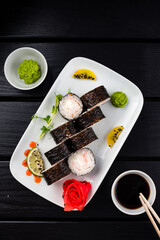 Sushi rolls with shrimps, cream cheese, wasabi, ginger and soy sauce.