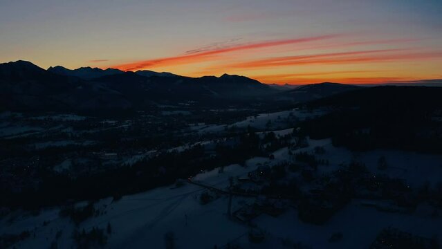 STUNNING Sunset with colourful sky in winter - Drone Aerial Shot of snow landscape