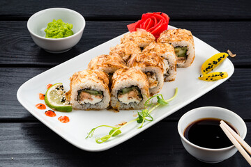 Lunch sushi rolls with tuna, cream cheese, cucumber, wasabi, ginger and soy sauce.