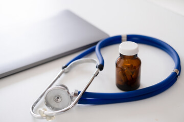 Stethoscope and Assorted pharmaceutical medicine pills In Hospital