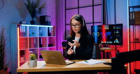 Business concept where beautiful confident skilled stylish dark haired businesswoman in headset...