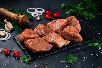 Portion pork for barbecue with onion, tomatoes, sauce and spices.