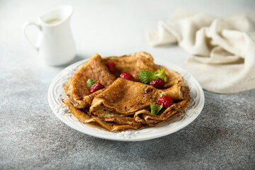Traditional homemade crepes with raspberry
