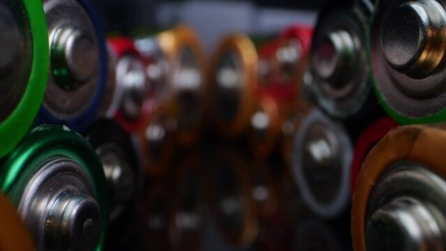 Macro view of used alkaline batteries, commonly found in household devices. Shot against a black backdrop.