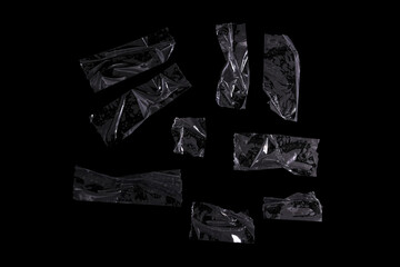 Photo isolated transparent tape pieces on black background