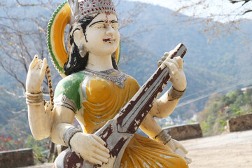Fototapeta premium Old sculpture of goddess Saraswati in Rishikesh.