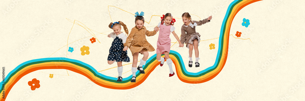 Wall mural cute little girls, children in retro clothes playing together, jumping over colorful rainbow. summer