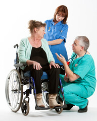 Health Professionals: Patient Care. A senior lady in a wheelchair receiving professional advice and reassurance. From a series of related images.