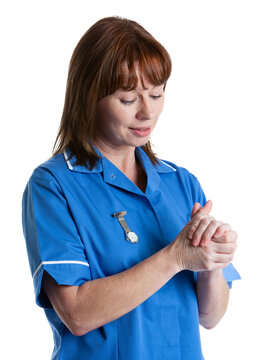 Health Professionals: Clean Hands. A uniformed medical nurse sterilising her hands. From a series of related images isolated on white.