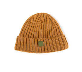 children's warm hat of beige mustard  ginger color for spring and autumn knitted isolated on a white background close-up