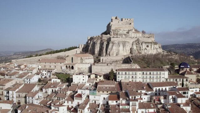 Lateral top aerial view of Morella, with the Archiprestal Church and its medieval castle on top of the hill, Spain