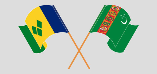 Crossed and waving flags of Saint Vincent and the Grenadines and Turkmenistan