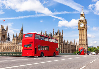 Red bus on Westminster bridge next to Big Ben in London, the UK.