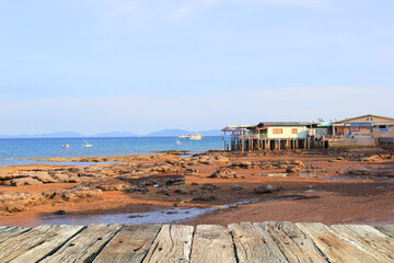 Wooden pier, wooden table on the beach with sea view background, Thailand.
