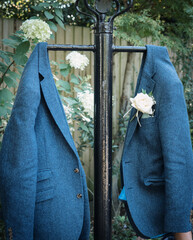 The wedding jackets, a pair of blue tweed jackets hanging up