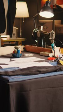 Vertical video Empty fashion atelier with tailor tools, handcraft and textile industry workshop with industrial instruments. Luxury atelier with sketches designs of items and needlework equipment.