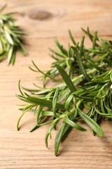 Fresh green rosemary on wooden table, closeup